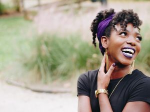 A woman smiles in a photo. This represents the emotional freedom and happiness that can come from working with a therapist. Our therapists provide high quality counseling and therapy in Colorado Springs, CO.