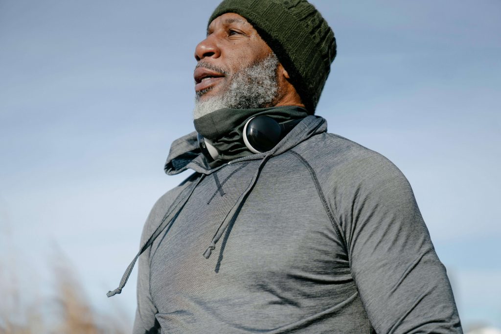 Man standing outdoors in athletic clothing, reflecting on mental health and seeking a therapist for men in Colorado Springs, CO.