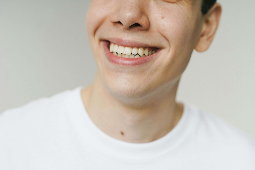Close-up of a man smiling, representing emotional resilience, healing, and growth supported by trauma therapy for men in Colorado Springs, CO.
