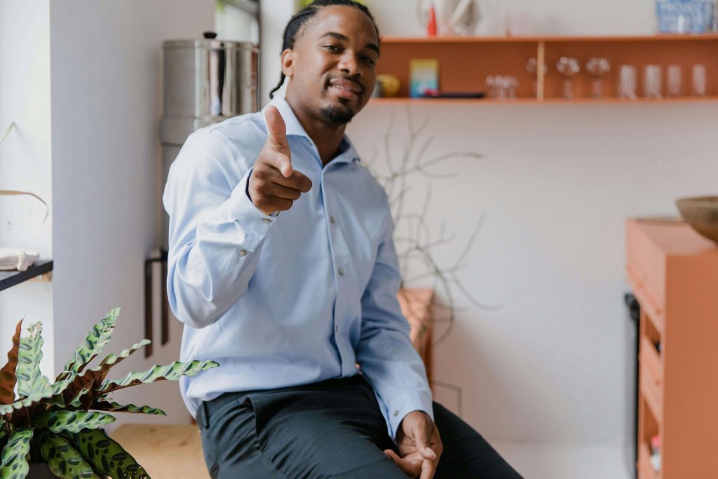Man in a button-up shirt smiling, symbolizing progress and growth through therapy for breaking cycles in Colorado Springs, CO.