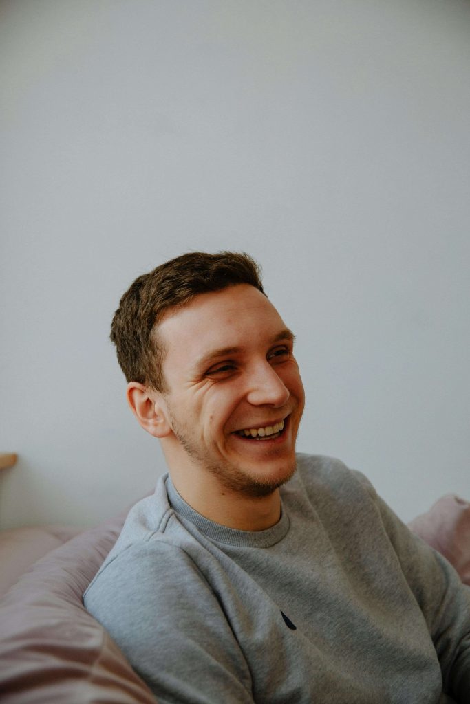 Man smiling and appearing carefree, symbolizing healing and progress through substance abuse counseling for men in Colorado Springs, CO.