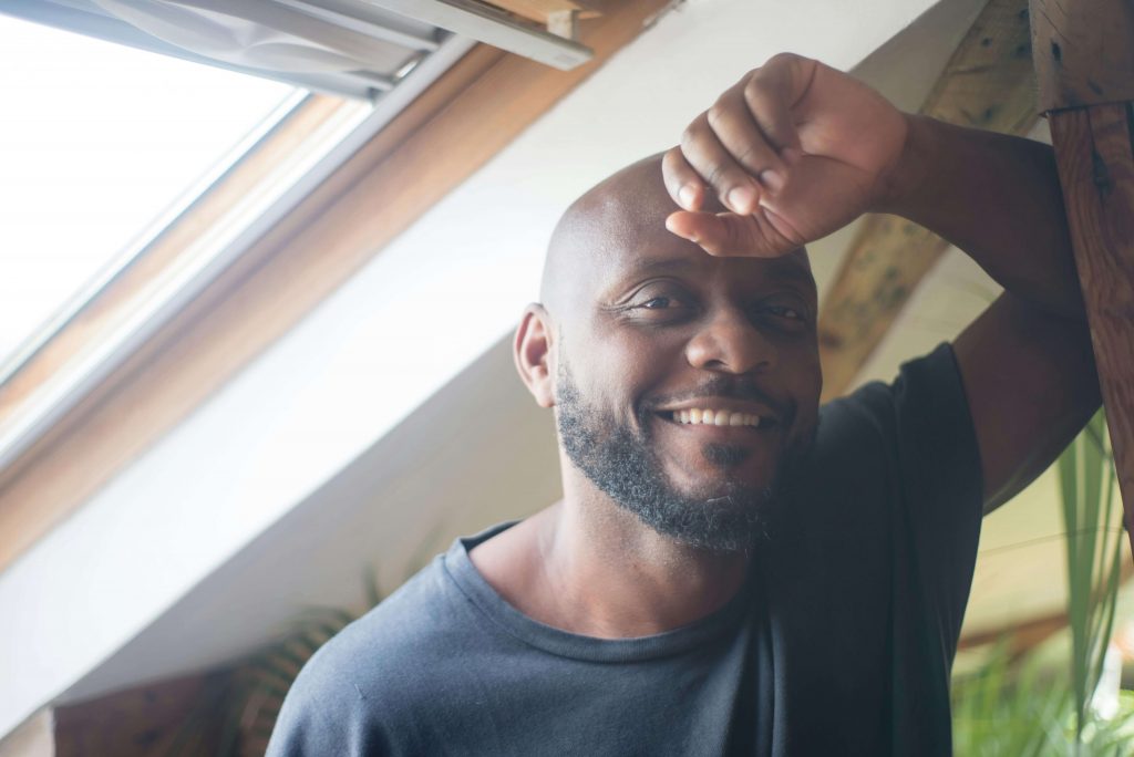 Man smiling with a hopeful and content expression, symbolizing growth and relief through therapy for perfectionistic men in Colorado Springs, CO.