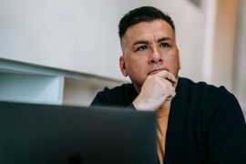 Man sitting in deep thought, representing internal pressure and reflection explored in therapy for perfectionistic men in Colorado Springs, CO.