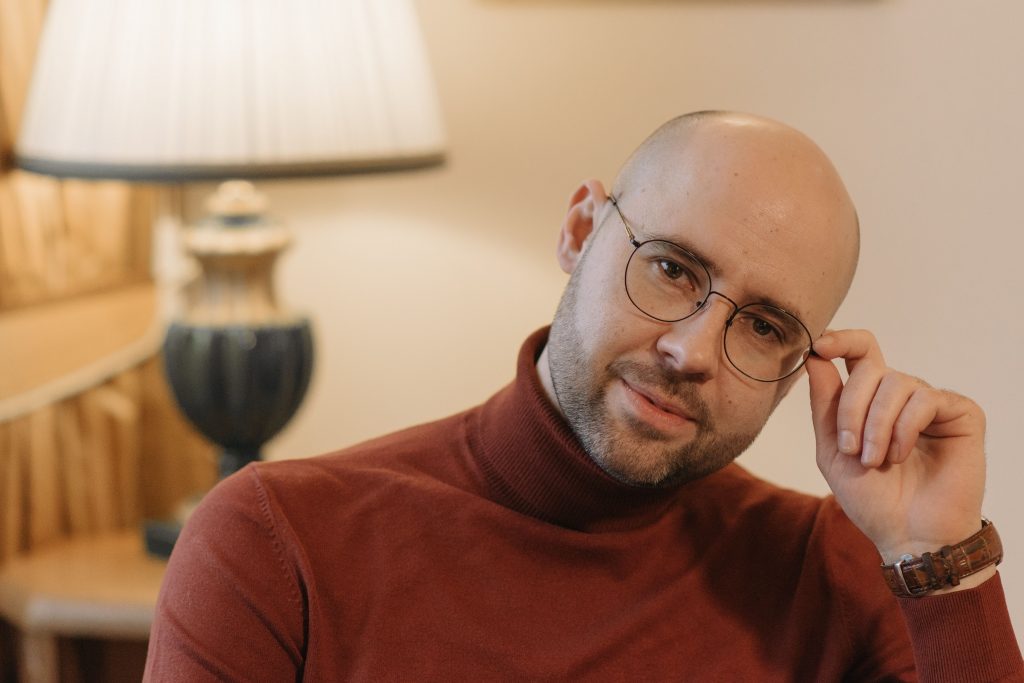 Man looking content and at peace, symbolizing growth, acceptance, and healing fostered through grief counseling for men in Colorado Springs, CO.