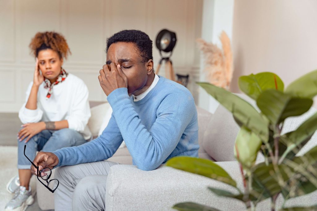 Relationship Challenges - therapist for men in colorado springs, co - counselor for men colorado springs co - mens therapy colorado springs, co Man appearing stressed during a couples therapy session, representing the communication and emotional concerns supported by a therapist for men in Colorado Springs, CO.