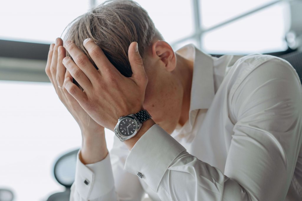 Carrying the Weight Alone - therapist for men in colorado springs, co - counselor for men colorado springs co - mens therapy colorado springs, co Man looking stressed, illustrating the emotional burden and overwhelm addressed by a therapist for men in Colorado Springs, CO.