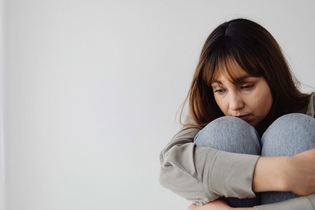 Emotional Exhaustion - depression therapist colorado springs co - depression therapy colorado springs co - depression counseling in colorado springs co - denver co Woman appearing withdrawn and distressed, representing the varied ways depression can affect daily life addressed with a depression therapist in Colorado Springs, CO.