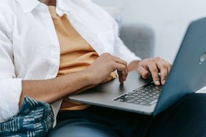 Man using a laptop, representing convenient and accessible mental health support through online therapy for men in Colorado Springs, CO.