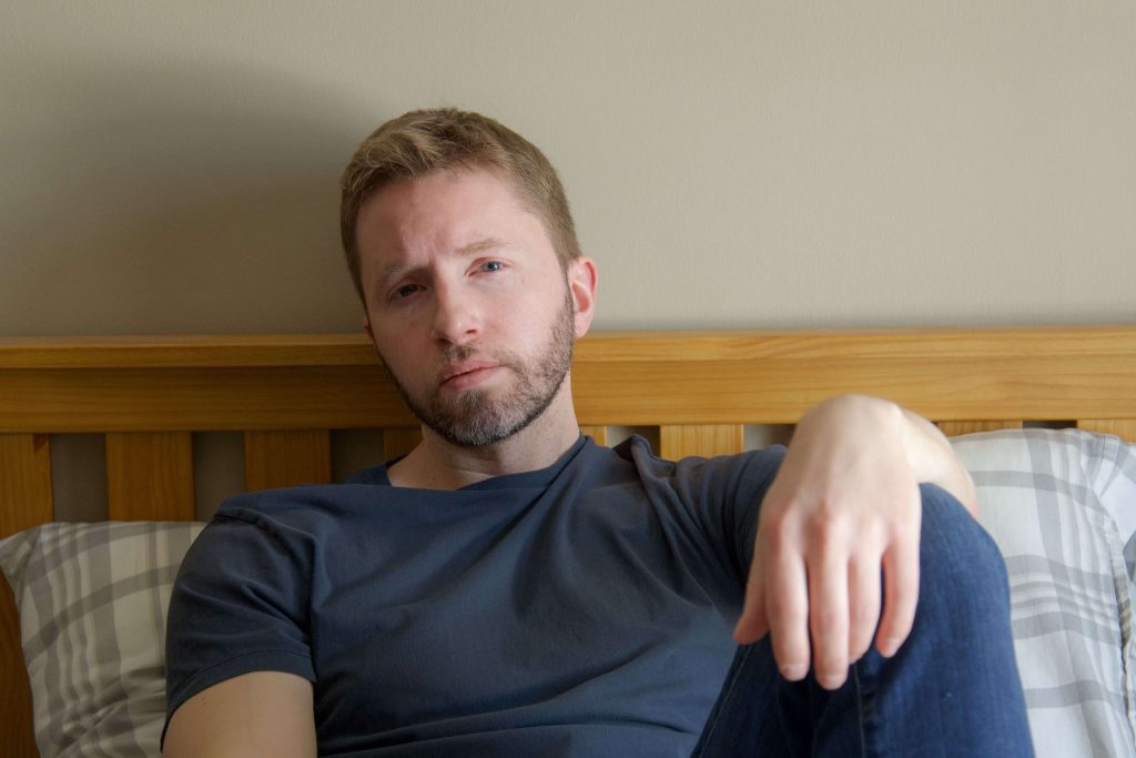 Thoughtful man reflecting on his emotions, symbolizing self-awareness and personal growth through therapy for men in Colorado Springs, CO.