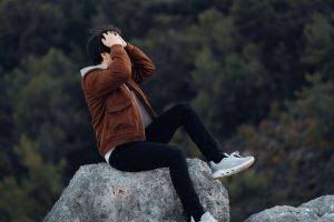 Man sitting in deep thought, representing persistent self-doubt and mental rumination explored through anxiety therapy for men in Colorado Springs, CO.