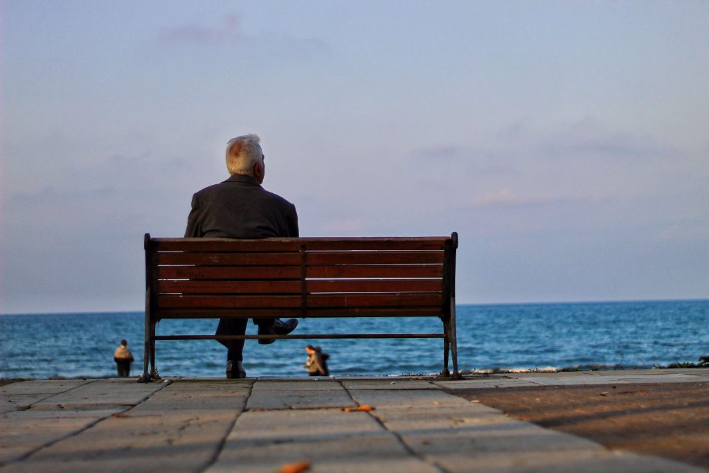 Lonely man sitting alone, reflecting feelings of isolation and disconnection that may be explored through therapy for men in Colorado Springs, CO.