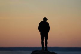 Man appearing lonely and withdrawn, representing emotional disconnection and loneliness addressed through therapy for men in Colorado Springs, CO.