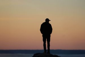 Man appearing lonely and withdrawn, representing emotional disconnection and loneliness addressed through therapy for men in Colorado Springs, CO.