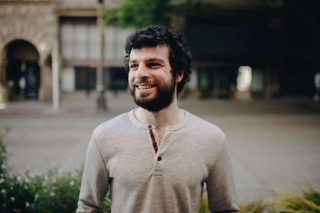 Happy man smiling, representing renewed confidence, connection, and emotional well-being supported through therapy for men in Colorado Springs, CO.